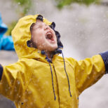 Shot of a young brother and sister playing in the rain