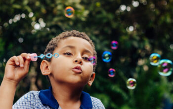 Boy playing soap bubble.